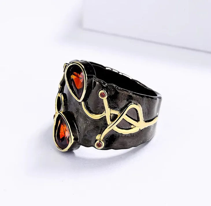 Women's black brass straight-pull oval ring on a neutral background
