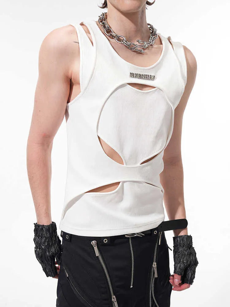 Man wearing a loose-fitting black sleeveless hollow thread waistcoat over a white t-shirt.