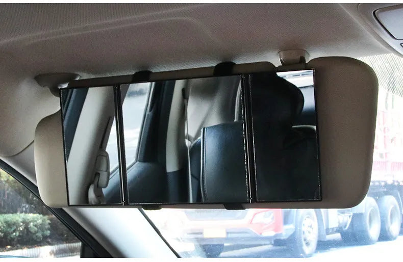 Silver folding car makeup mirror shown both closed and open on a car dashboard.