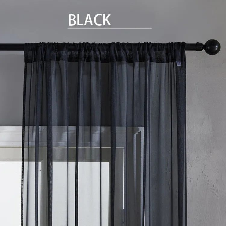 Modern simple pure black cotton linen polyester vertical window curtain hung, showing light transmission and textured craft detail.