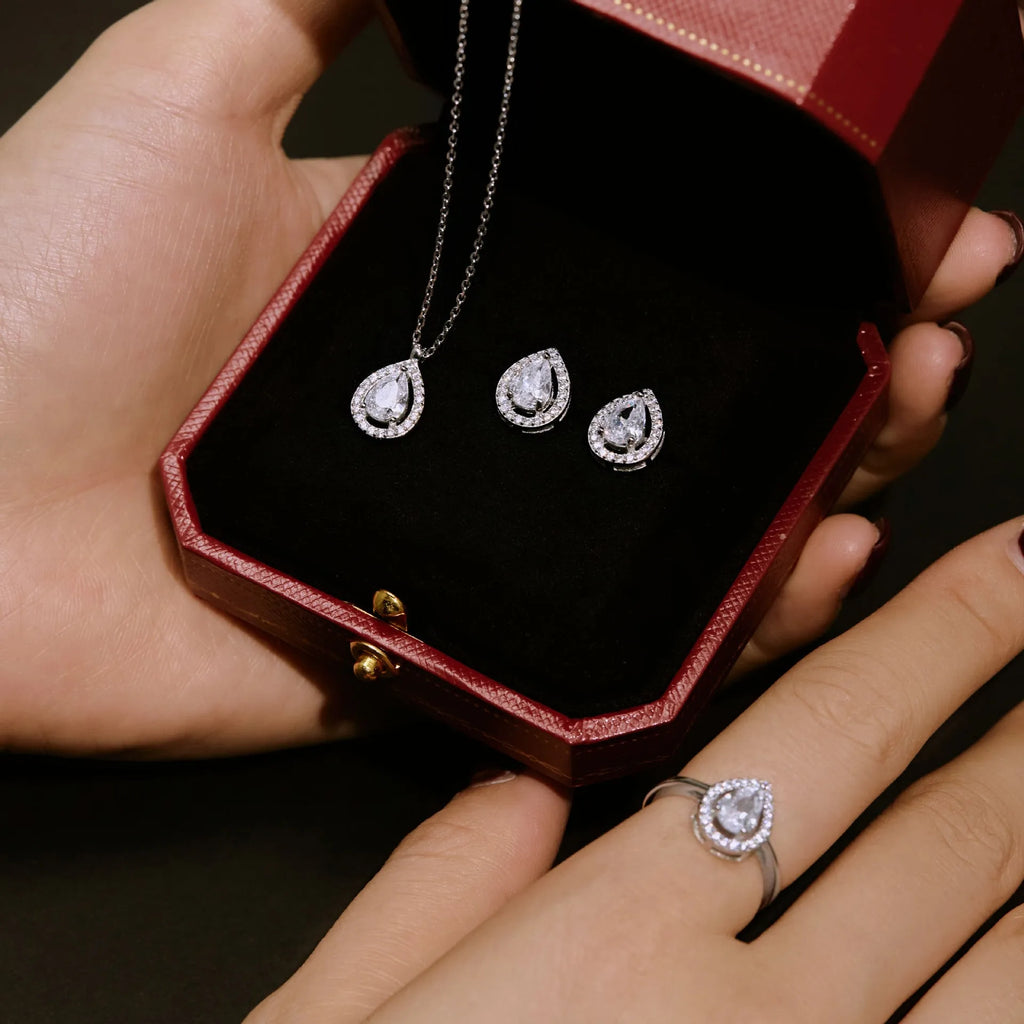 S925 sterling silver ring with drop-shaped diamond zircon stone in light luxury style on a plain background