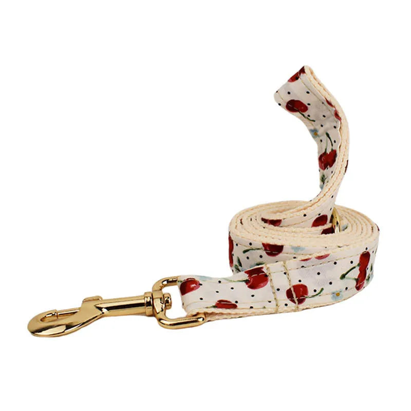 Red cherry print dog collar and leash set with light gold buckle and detachable bow strap