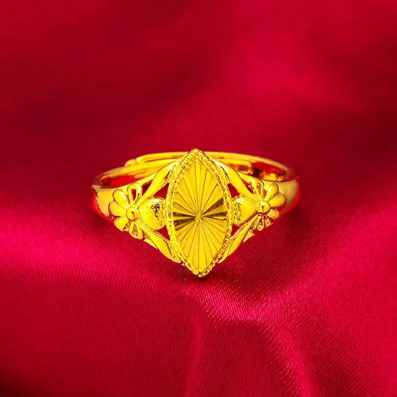 Adjustable gold-coloured brass floral ring with openwork design and textured diamond details.