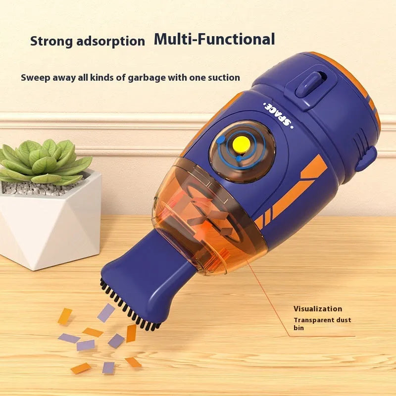 Blue rocket-shaped USB rechargeable handheld desktop vacuum cleaner on a wooden desk next to a keyboard