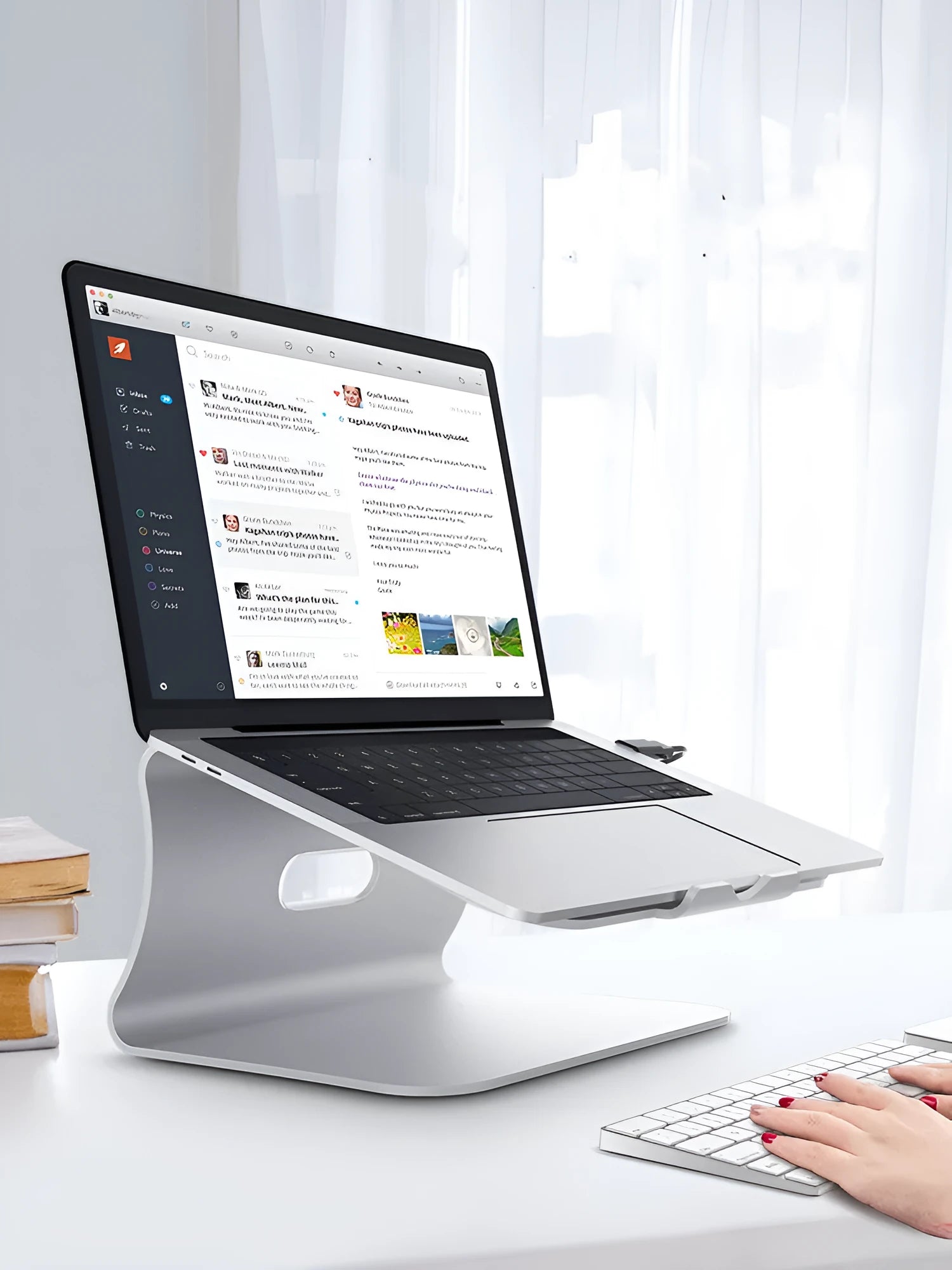 Silver aluminium laptop cooling stand with striped design on a wooden desk, rotated to show profile.
