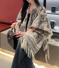 Women's free-size polyester scarf cape with tassel fringe in a choice of colours.