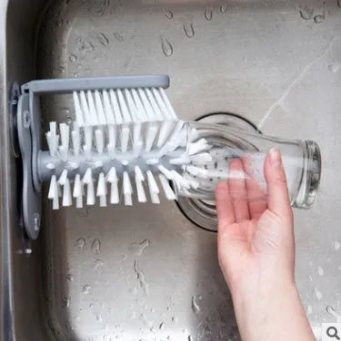 Grey rotating cup brush with dual heads and suction cups for wall mounting