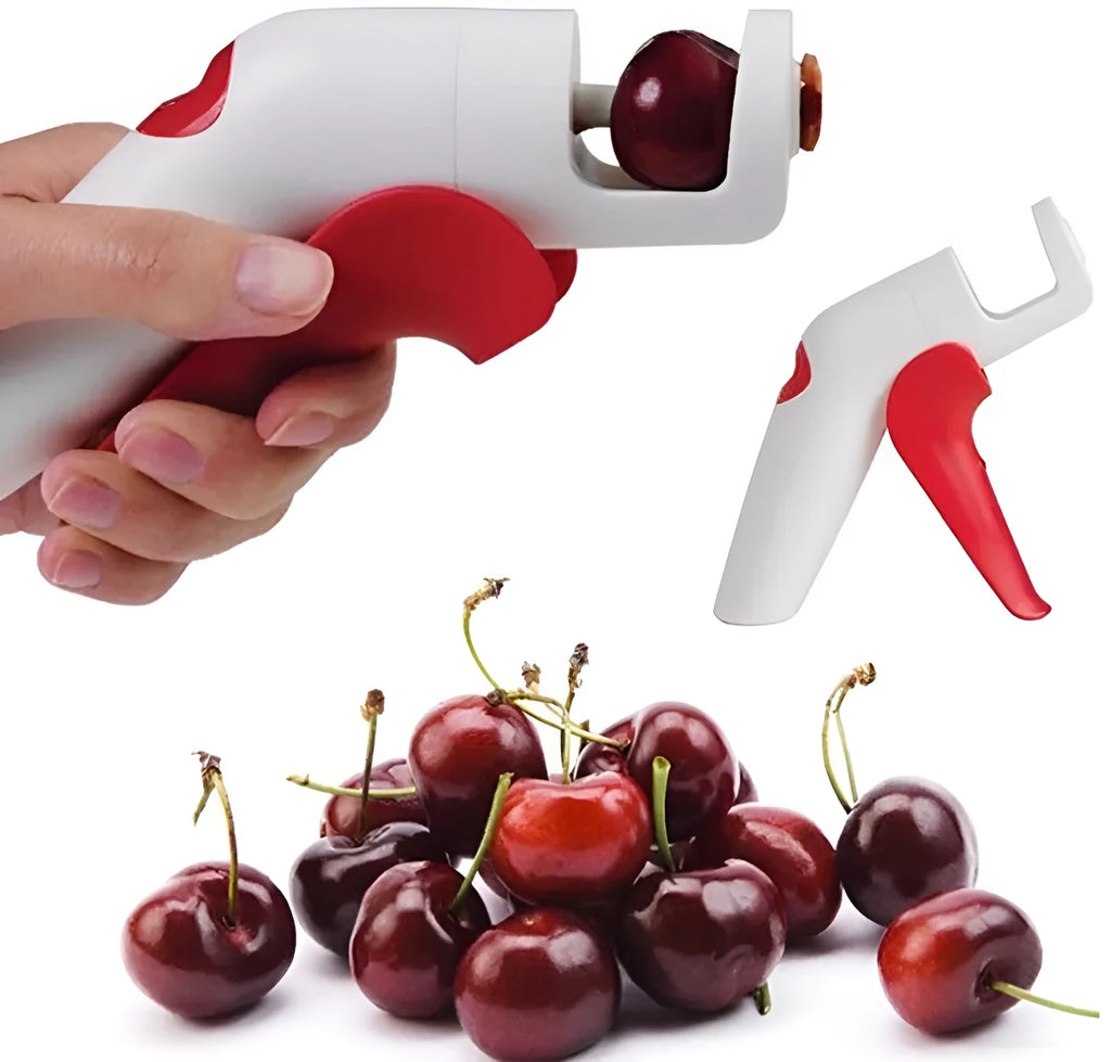 Stainless steel manual cherry pitter tool with protective end caps on a wooden surface.