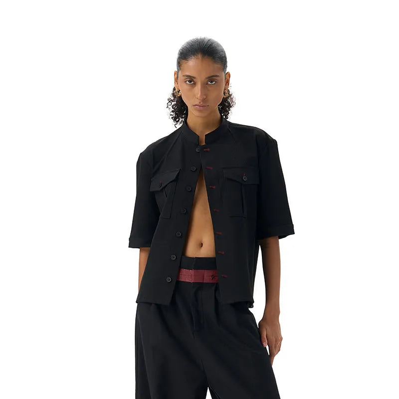 Black loose-fit half-sleeve hunting shirt with a shirt collar on a hanger.