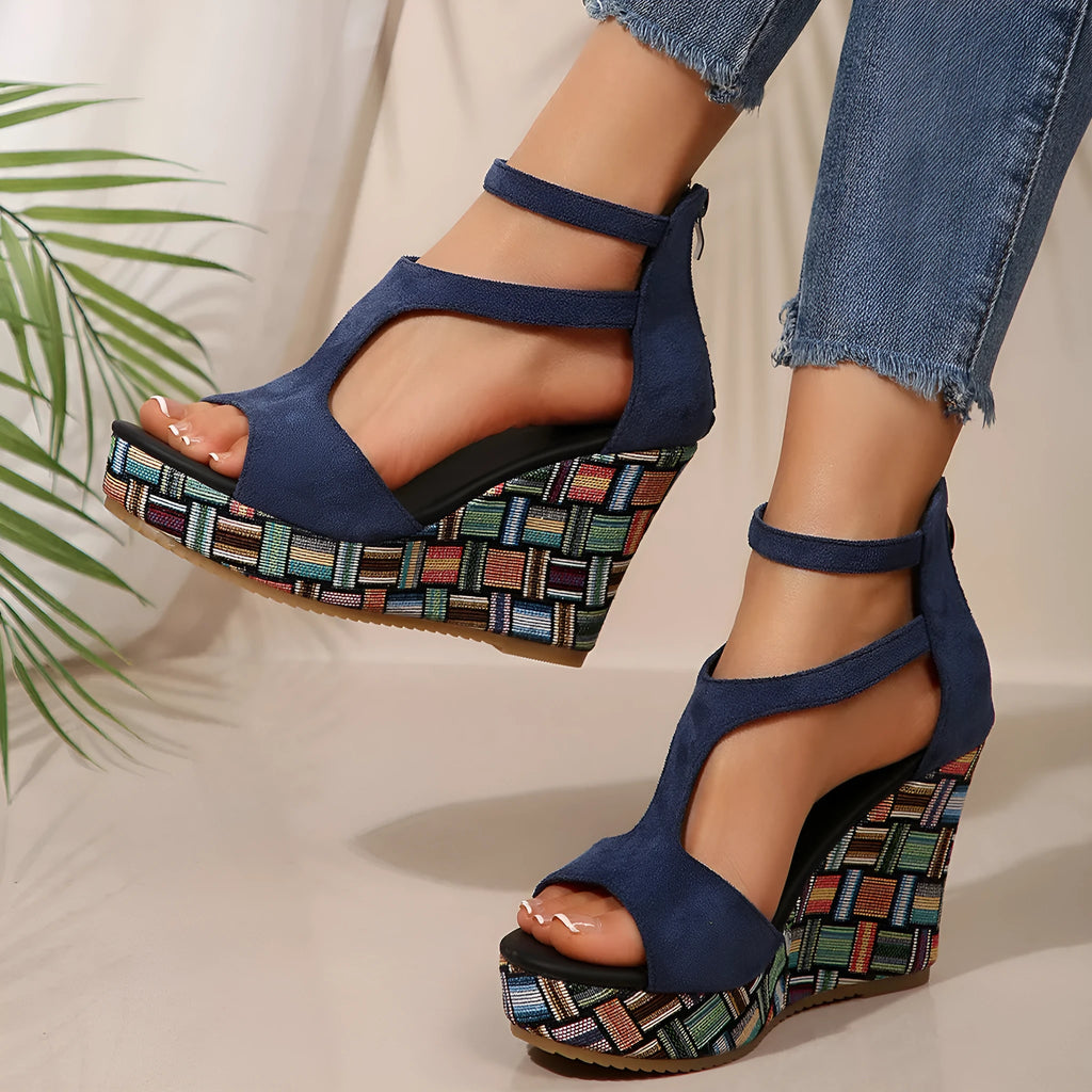 Women's beige ankle-strap sandals with a buckle and thick, textured rubber soles on a plain background.
