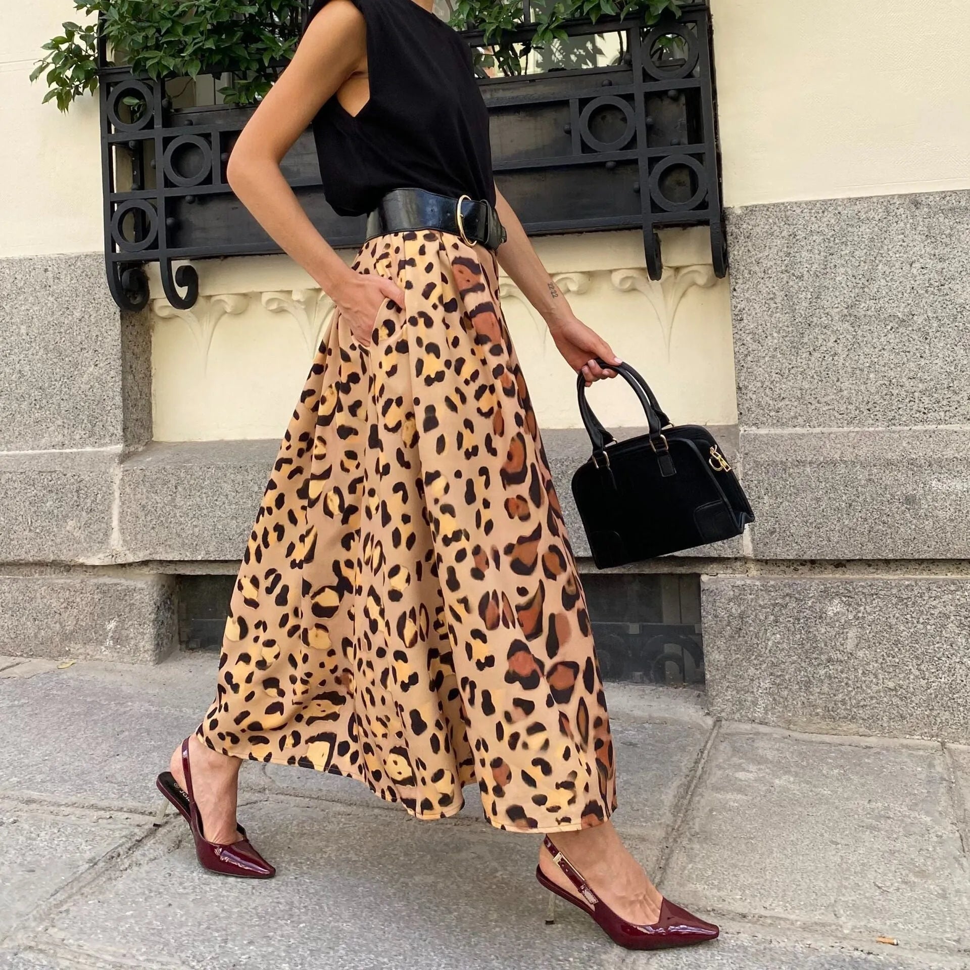 Brown leopard print women's long A-line skirt with a deep hem, shown on a hanger.