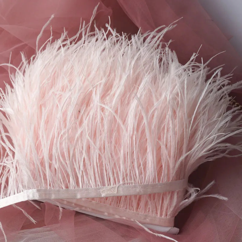 Decorative feather cloth strip in multiple colours including white, black, and mint green for DIY clothing and craft projects