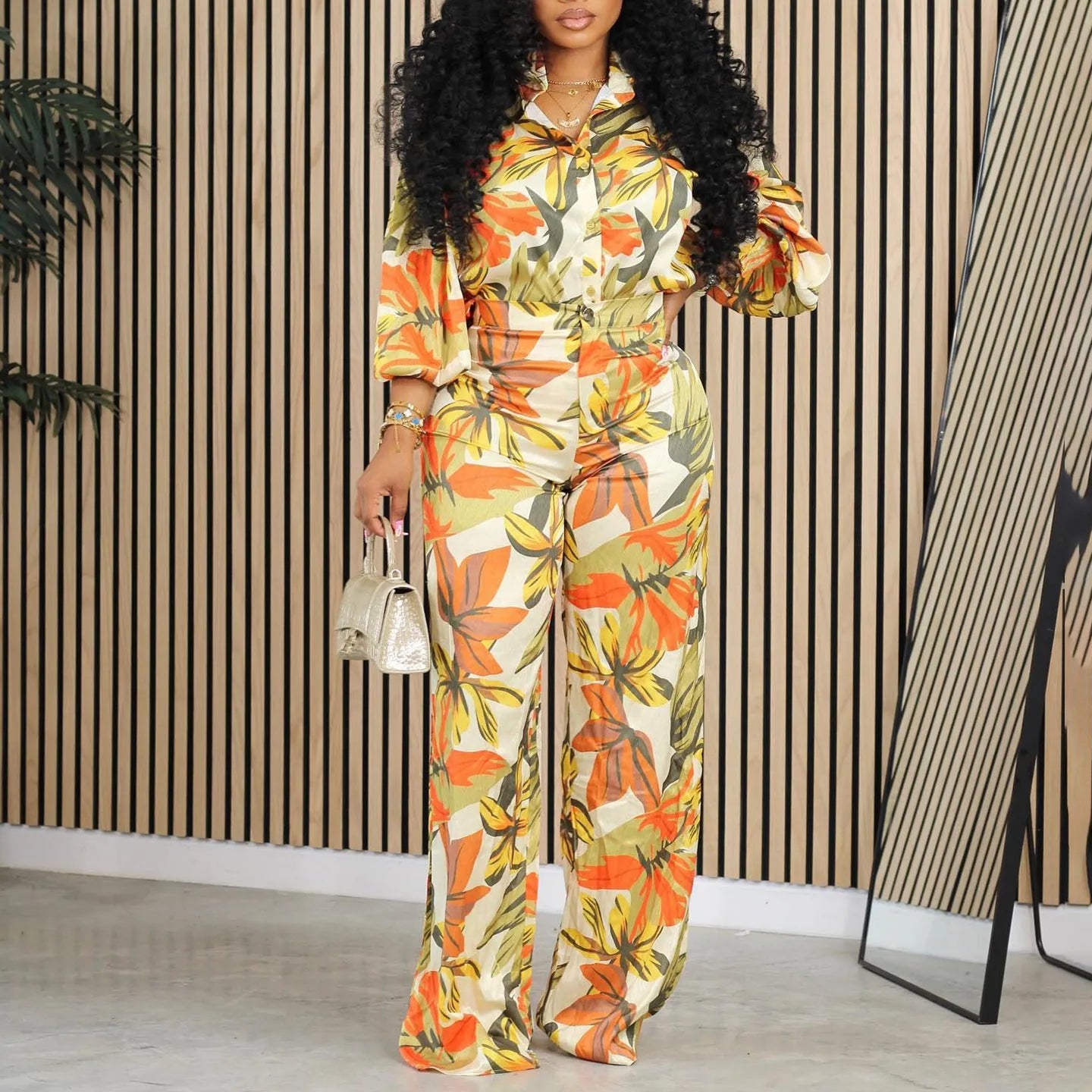 Red printed polyester women's shirt and wide leg trousers suit set showing front view