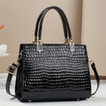 Women's soft PU one shoulder handbag showing multiple internal zip compartments and neutral colour option