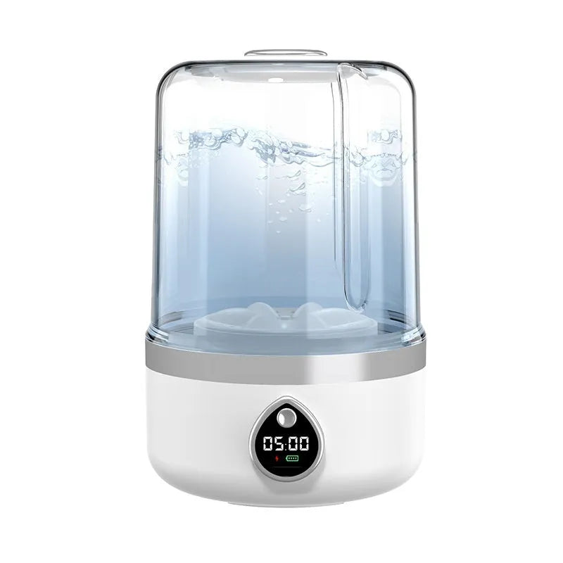 Portable white mini washing machine with USB cable on a countertop.