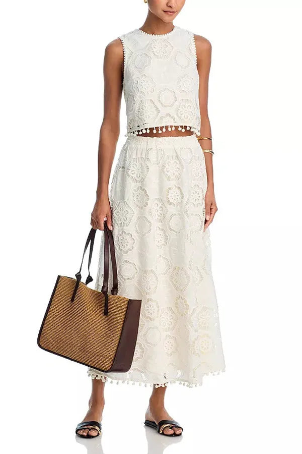 White sleeveless women’s suit with embroidered long skirt and top set