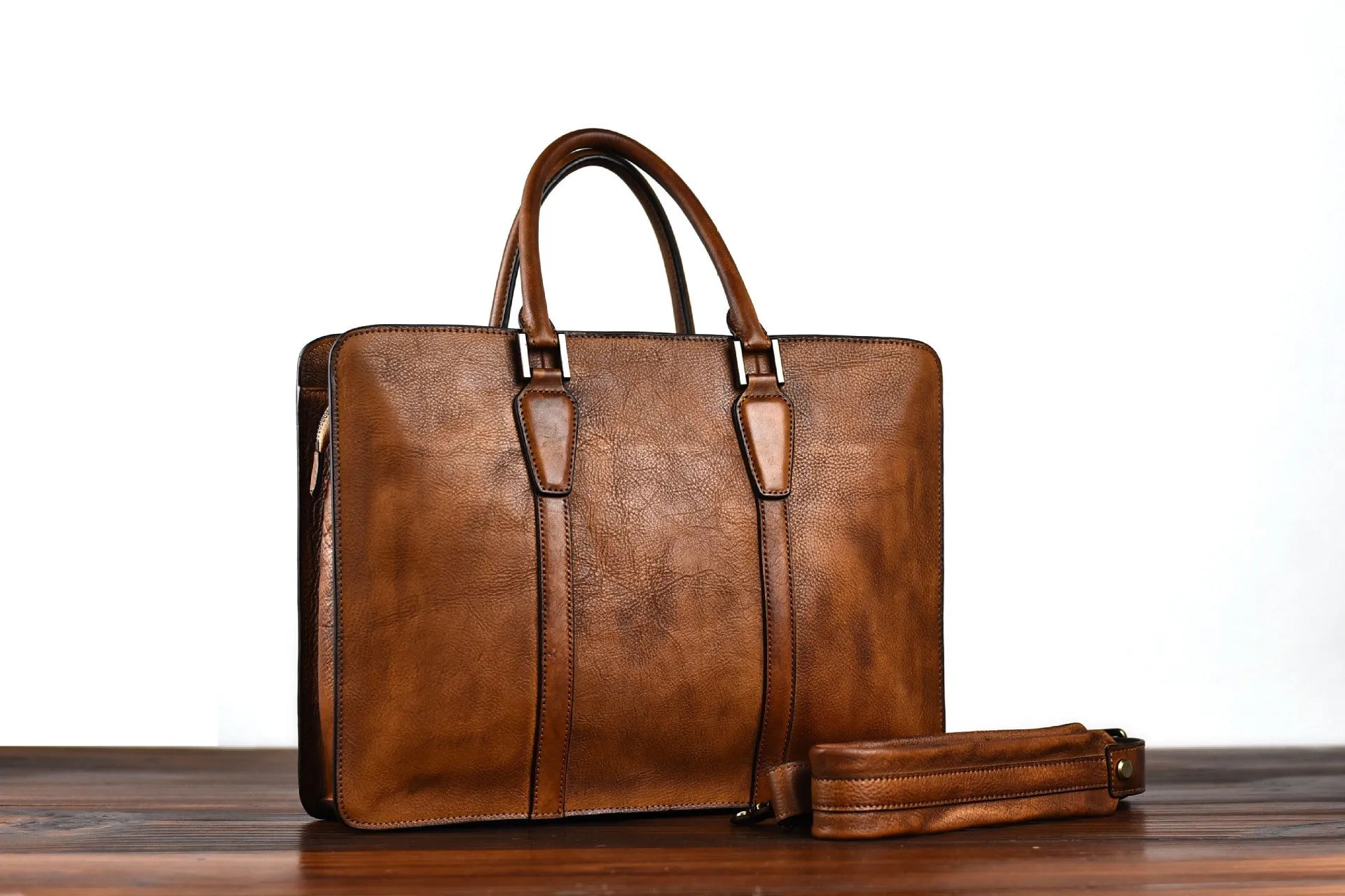 Men's brown leather handbag with horizontal square design and zipper closure