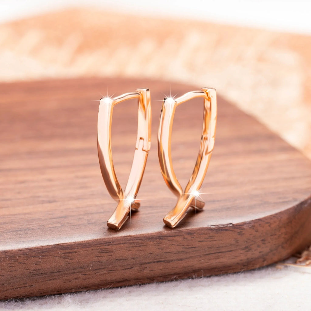 Rose gold plated cross-shaped earrings showing front design with post fitting.