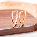 Rose gold plated cross-shaped earrings showing front design with post fitting.