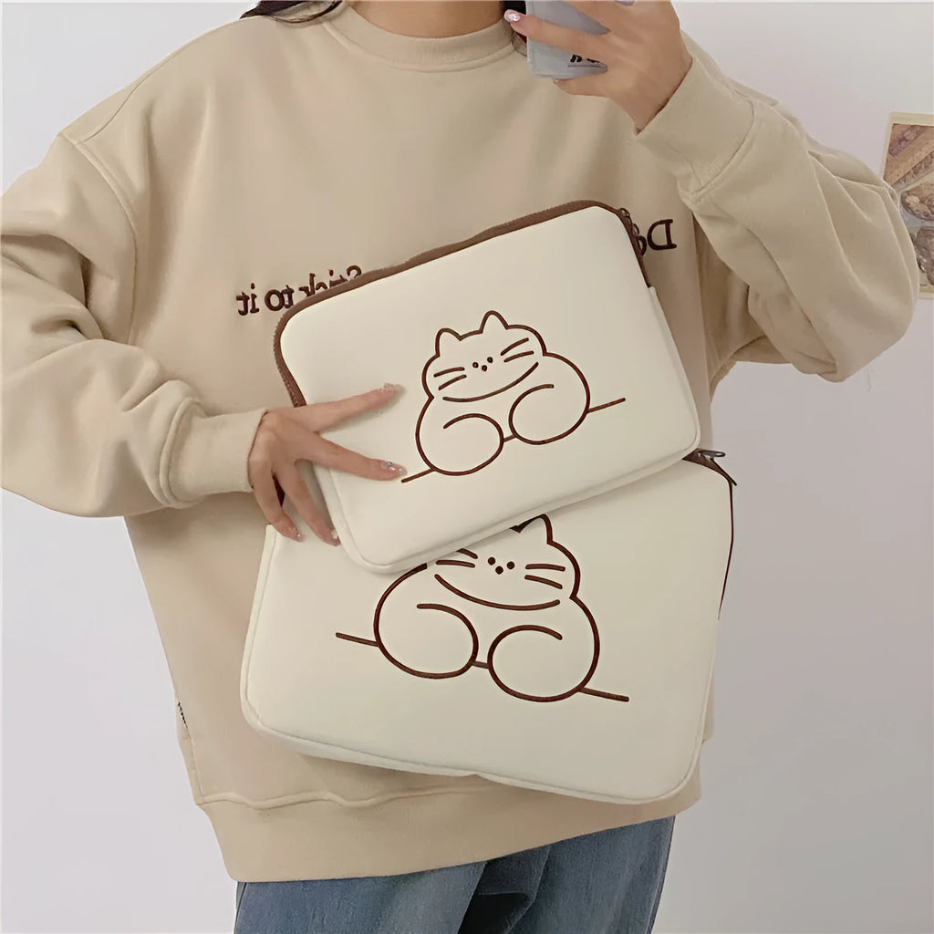Embroidered fat cat design on a grey nylon tablet protective sleeve with a black zipper.