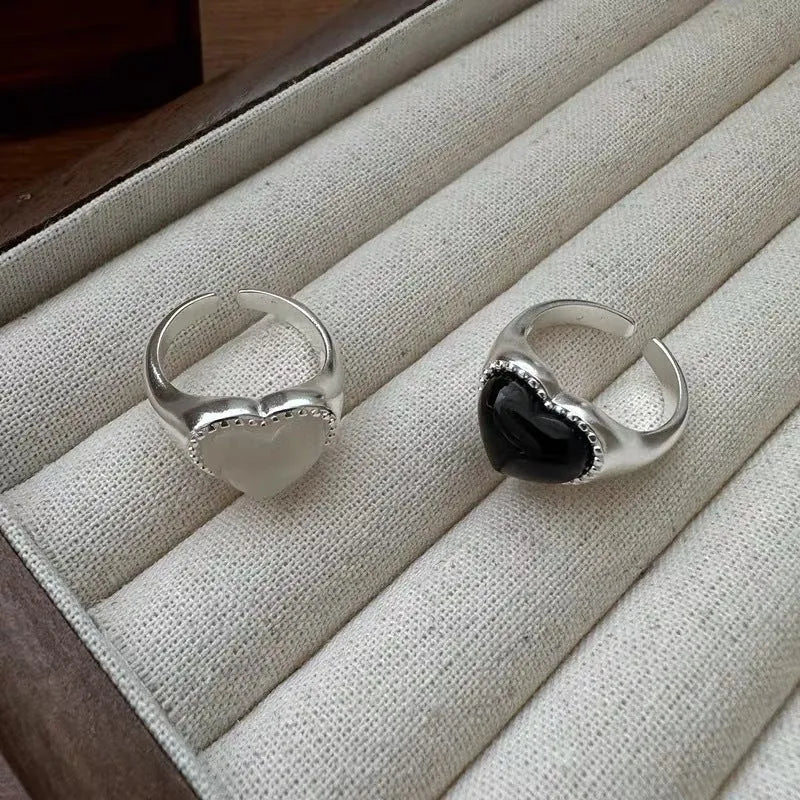Black agate heart ring in sterling silver with an adjustable open mouth design.