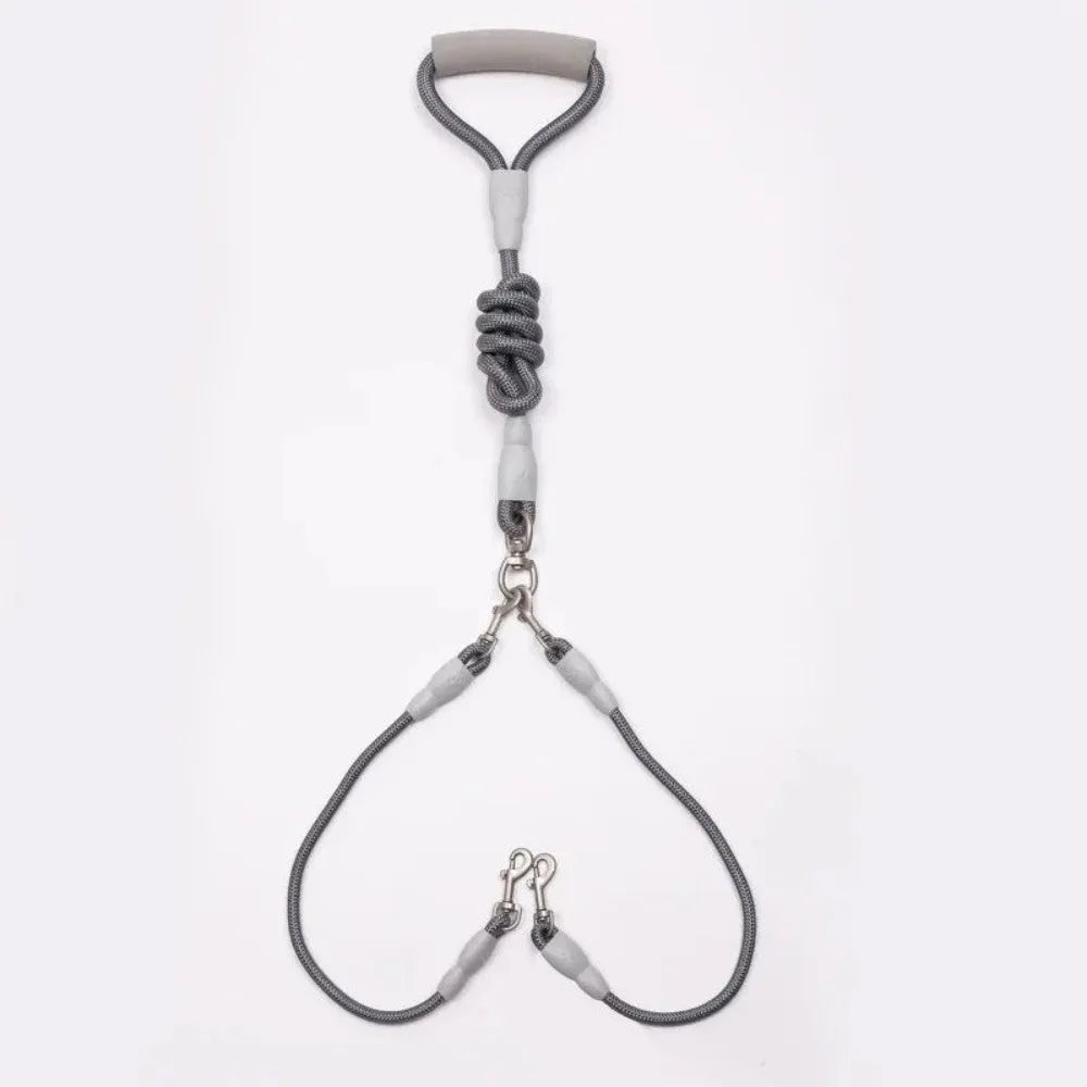 Blue double dog leash for two small dogs with a soft foam handle and metal clips.