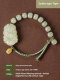 Hetian Jade Zodiac Bracelet on wrist showing rabbit charm, silver card, and red ice cotton rope.