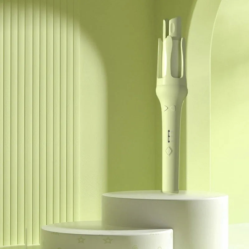 White and pink automatic hair curler with a 32mm rotating ceramic barrel and clamp, resting on a table with international power adapters.