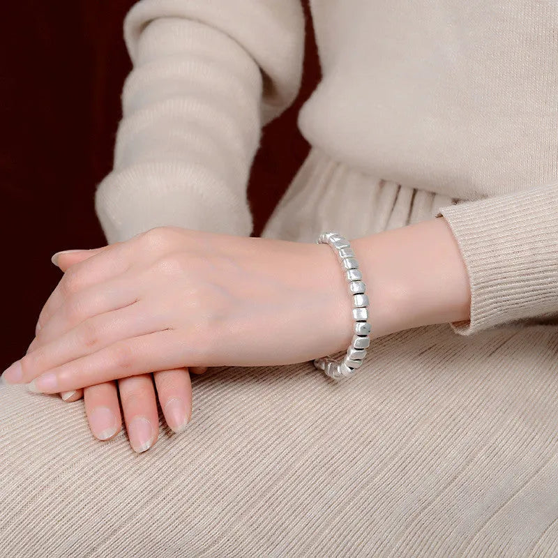Handmade silver bracelet with irregular square design and wooden elements on 17cm elastic band