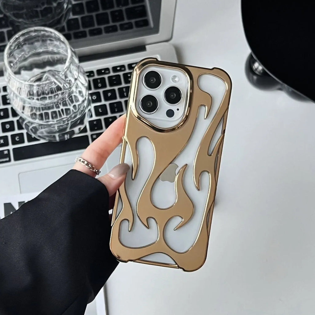 Electroplated hollow flame pattern phone case for iPhone on a table, showing silver metallic finish and cut-out design.