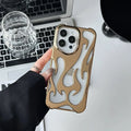 Electroplated hollow flame pattern phone case for iPhone on a table, showing silver metallic finish and cut-out design.