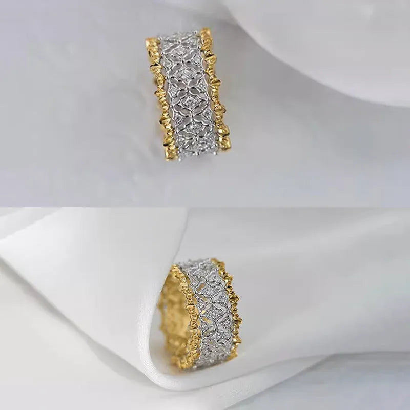 A geometric two-tone gold zircon ring on a white background, showing its round centre detail and copper band.