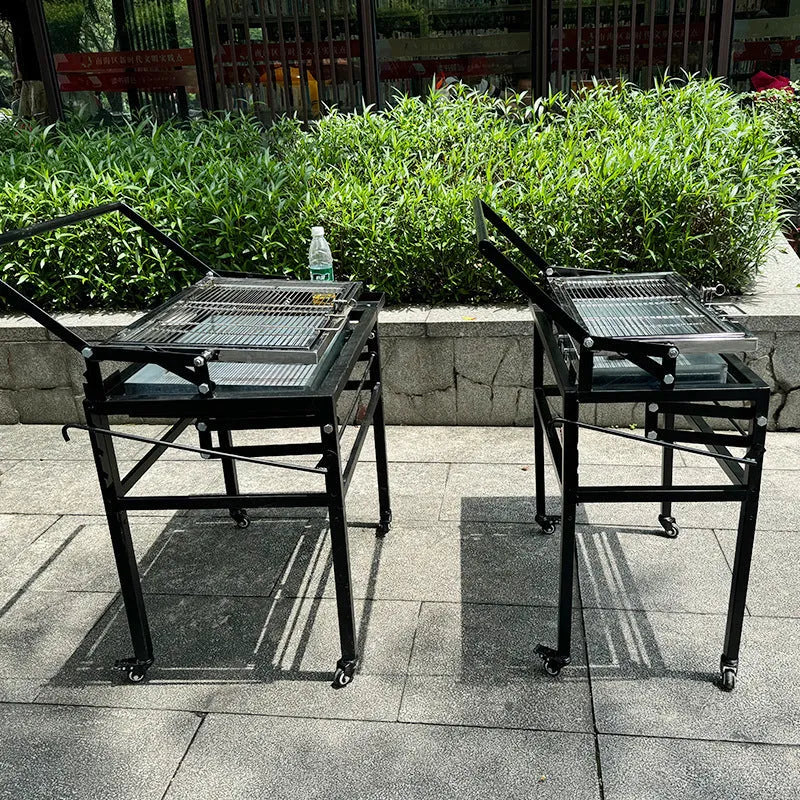 Large foldable charcoal BBQ stove set up in a garden.