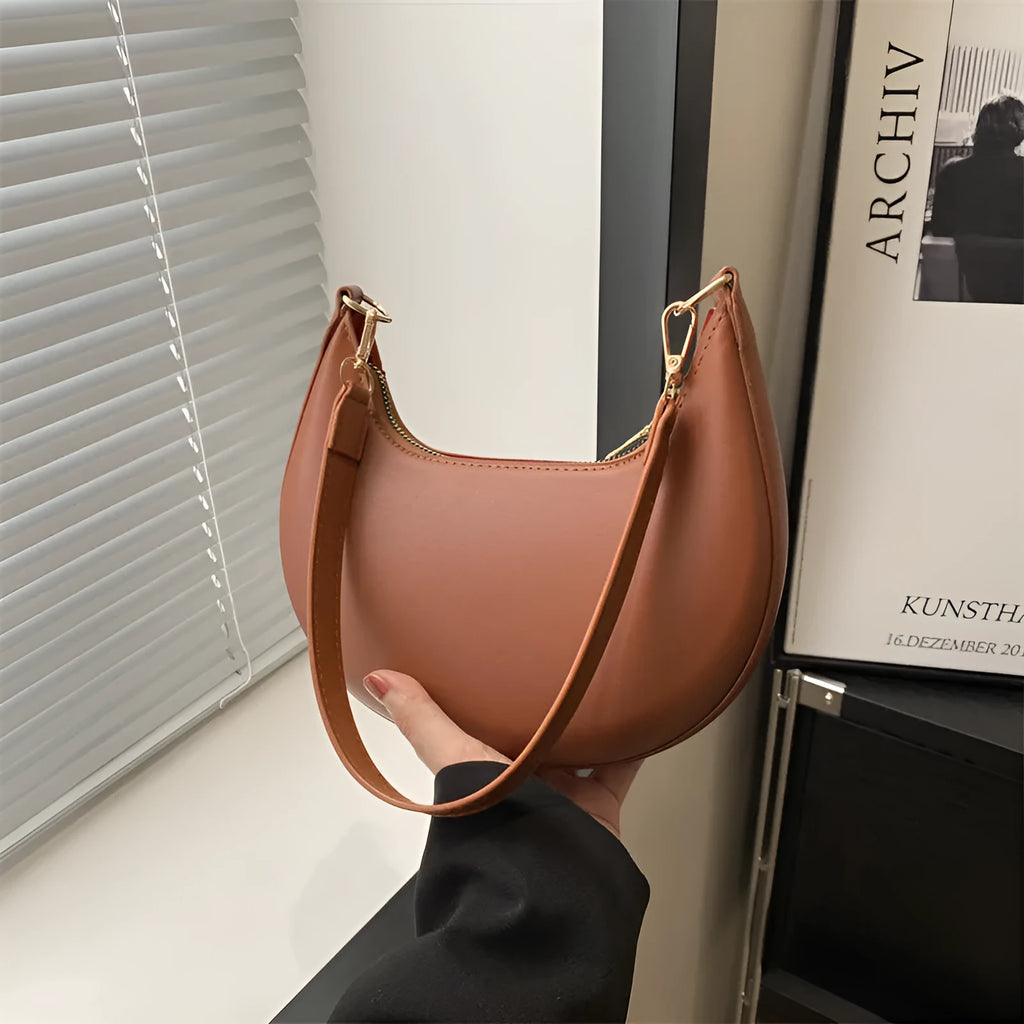 Round green one-shoulder underarm bag with visible sewing lines and sandwich-style compartments