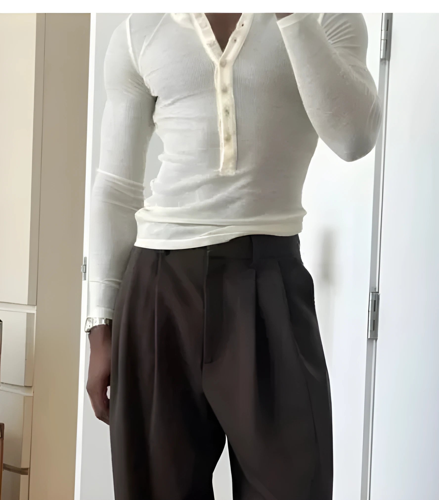 Men's cream ribbed long-sleeve henley top with button-up placket on a hanger.