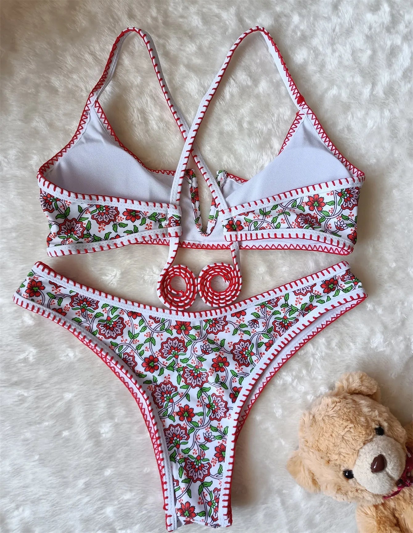 Women's V-neck swimsuit with embroidered detail and floral printed pattern in briefs style