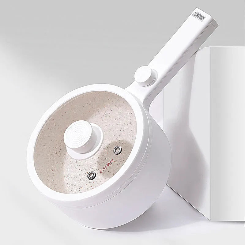 White and green multi-function electric cooking pot with temperature control dial and conversion plugs