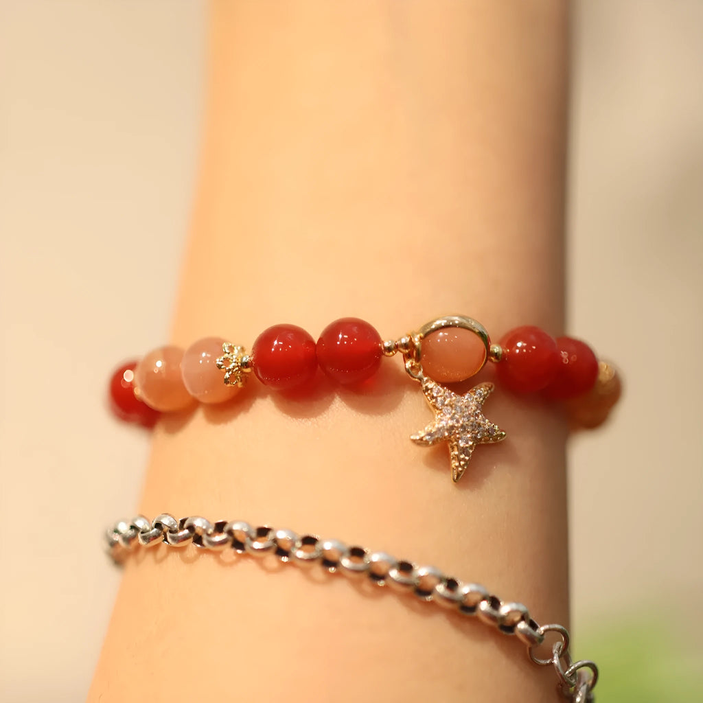 Handmade women's bracelet with 8mm red agate and orange sunstone beads, featuring star and cloud designs.