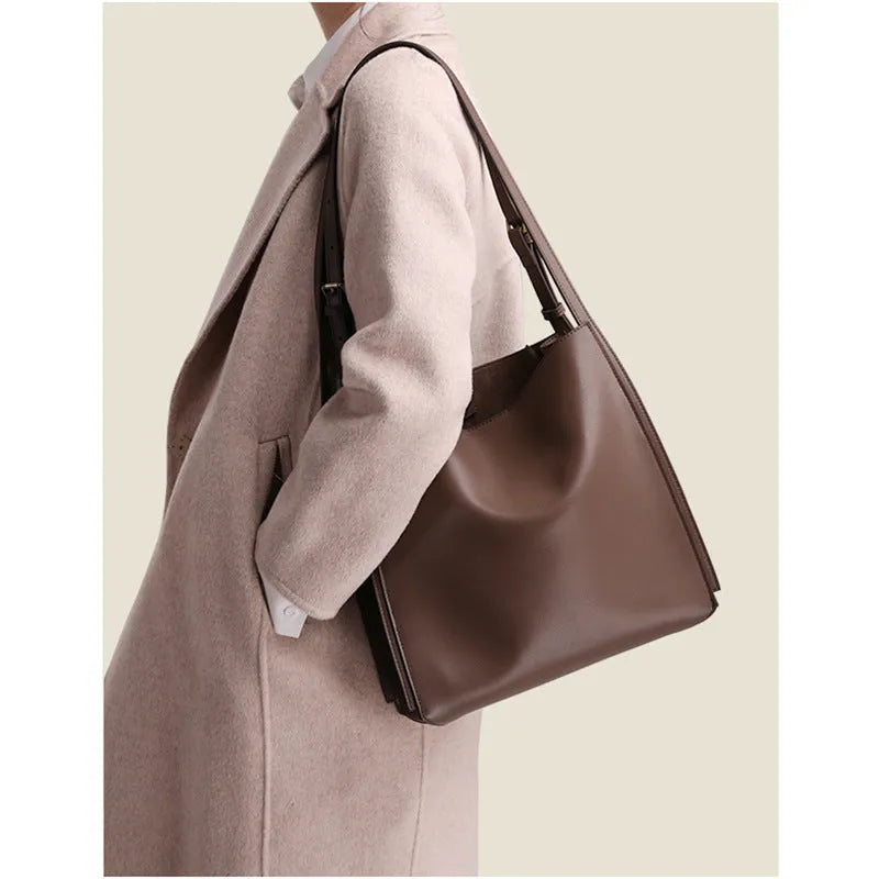 Brown genuine leather women's commuter bag with shoulder straps showing interior organisation compartments