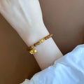 Women's caramel beeswax Lily charm bracelet with electroplated finish and New Chinese style design.