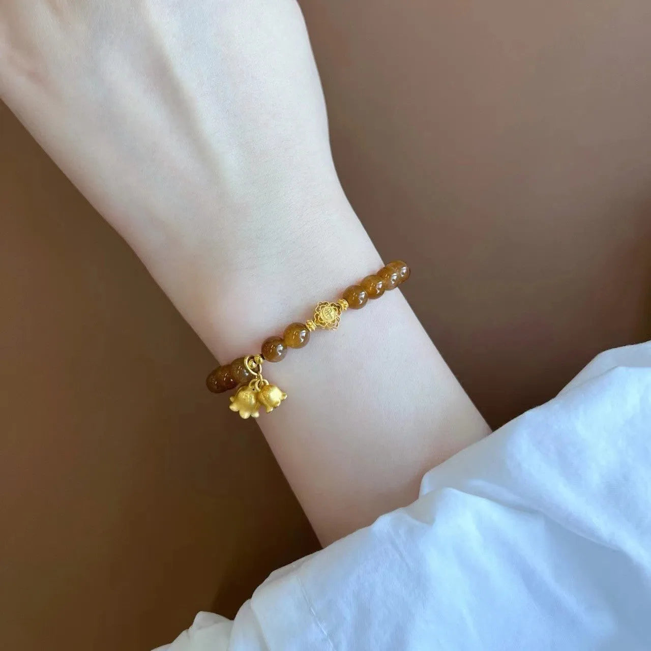 Women's caramel beeswax Lily charm bracelet with electroplated finish and New Chinese style design.