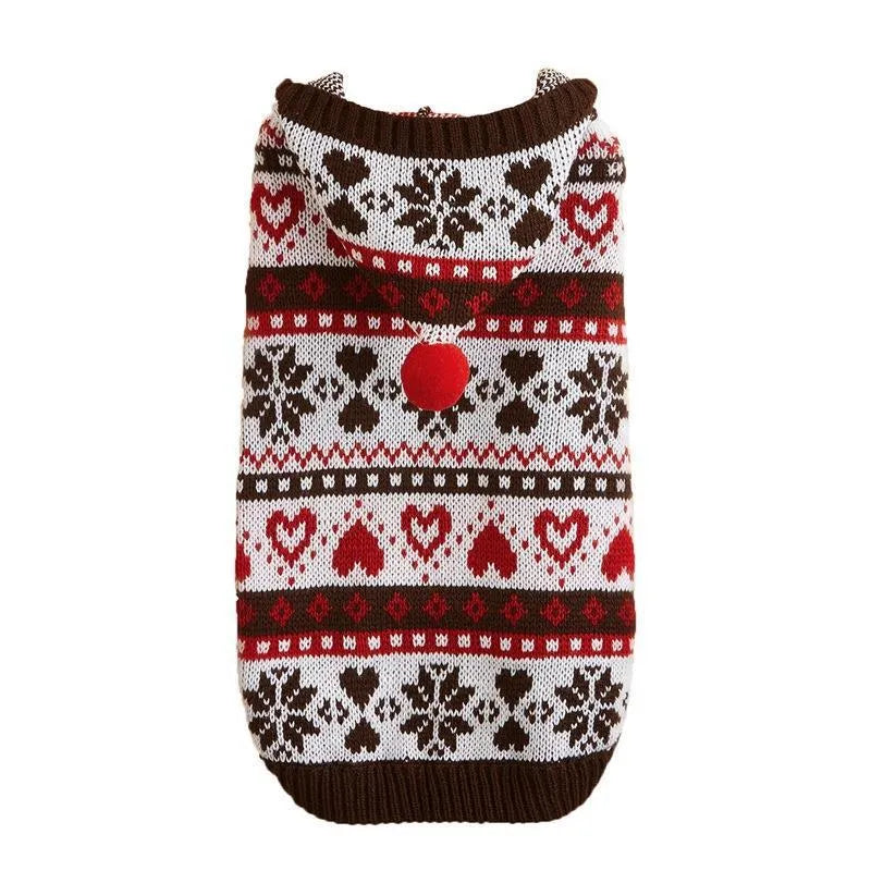 Blue knitted dog sweater with white snowflake and love heart patterns on a striped camouflage background.