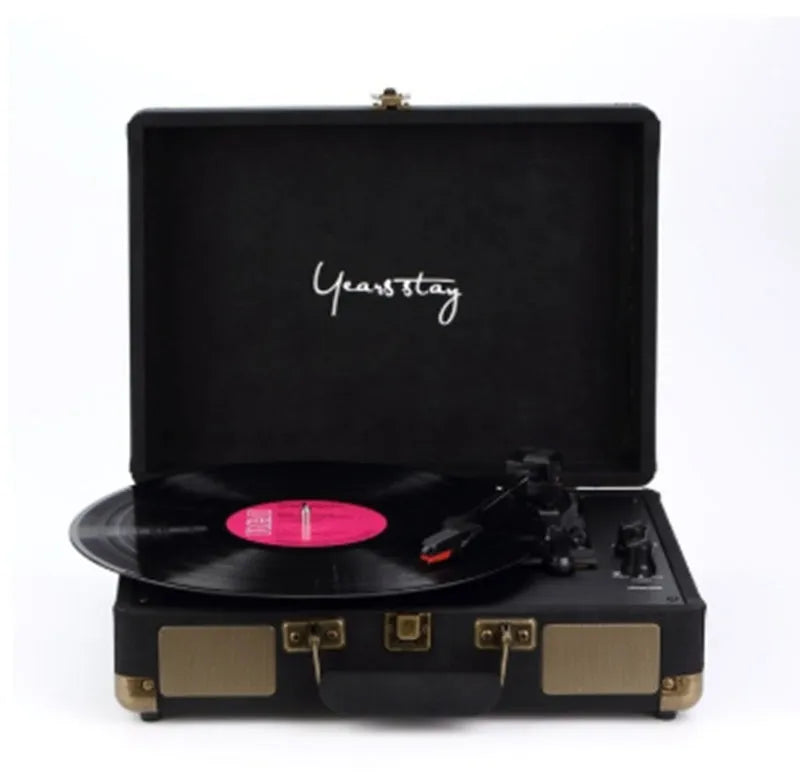 Portable Bluetooth vinyl turntable in a leather carrying case shown in multiple colour options