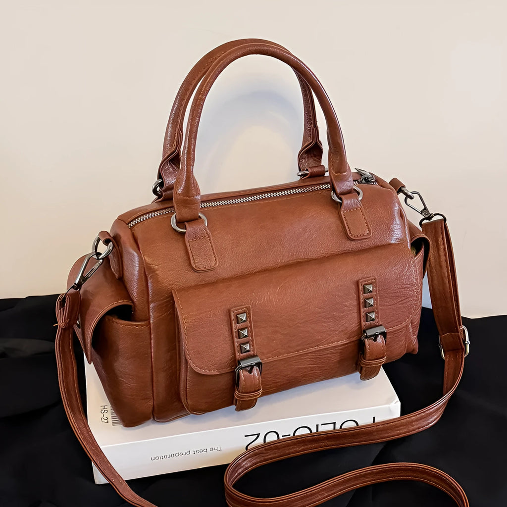 Large vintage-style messenger bag in a horizontal square shape, showing stitching detail, displayed in multiple colour options.