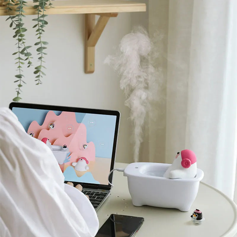 White compact USB air humidifier with large water tank on a desktop.