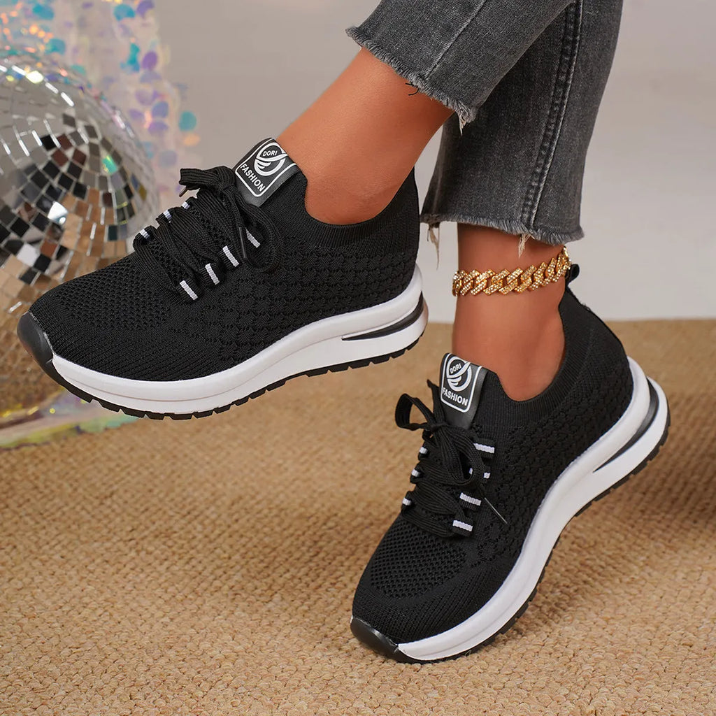 Women's black platform flat pumps with mesh upper and lace-up design on rubber sole