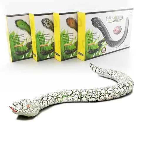Green remote control snake toy with retractable tongue and swinging tail on floor