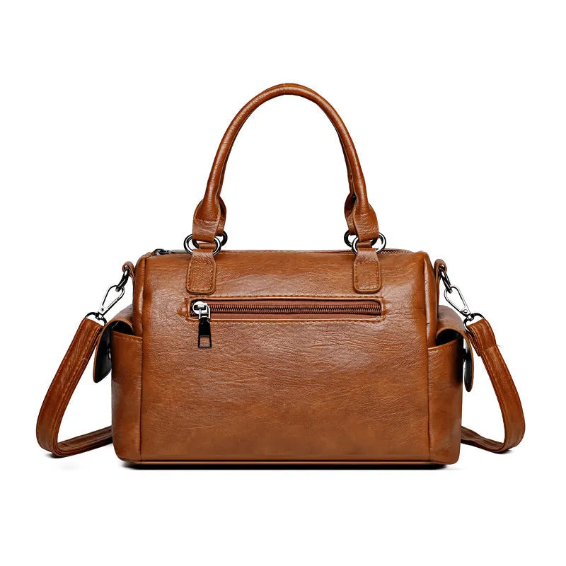 Large vintage-style messenger bag in a horizontal square shape, showing stitching detail, displayed in multiple colour options.