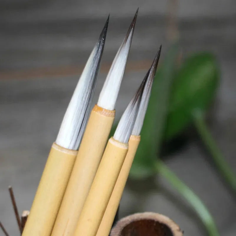 Four gold-body writing brushes with mixed-hair heads in pine branch colour set