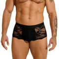 Men's black lace briefs with a hollow-out, see-through design on a neutral background.